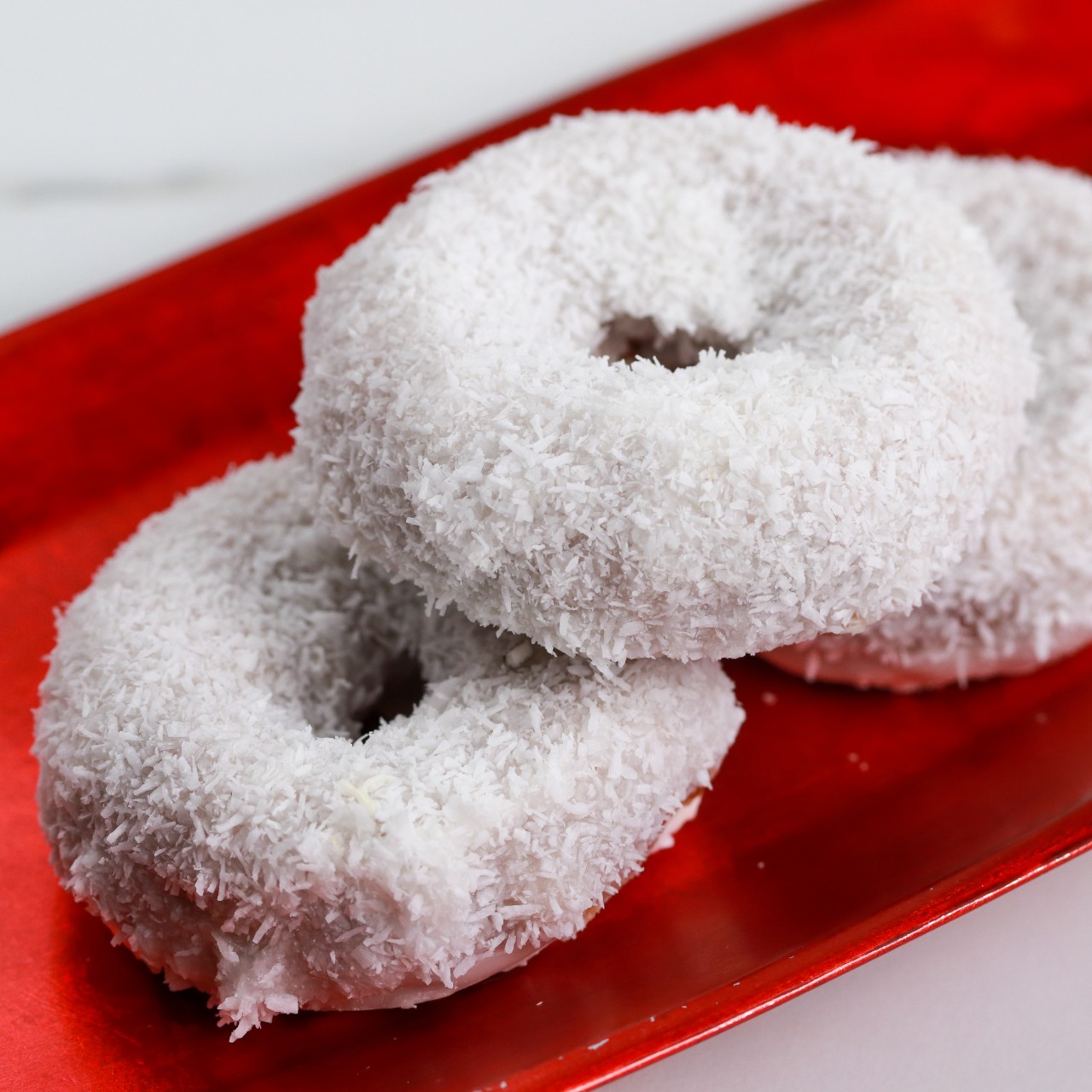 Vanilla Donut covered in shredded coconut