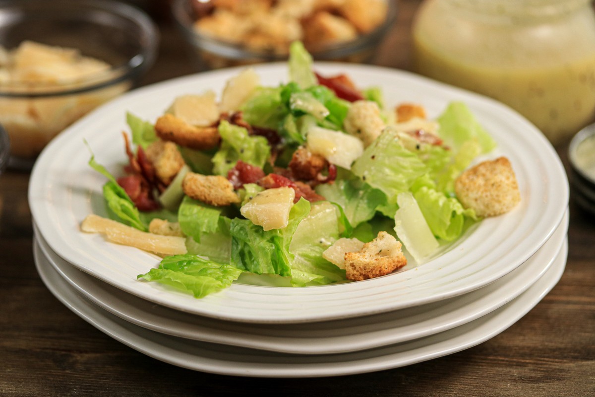 Caesar Salad on top of three white plates