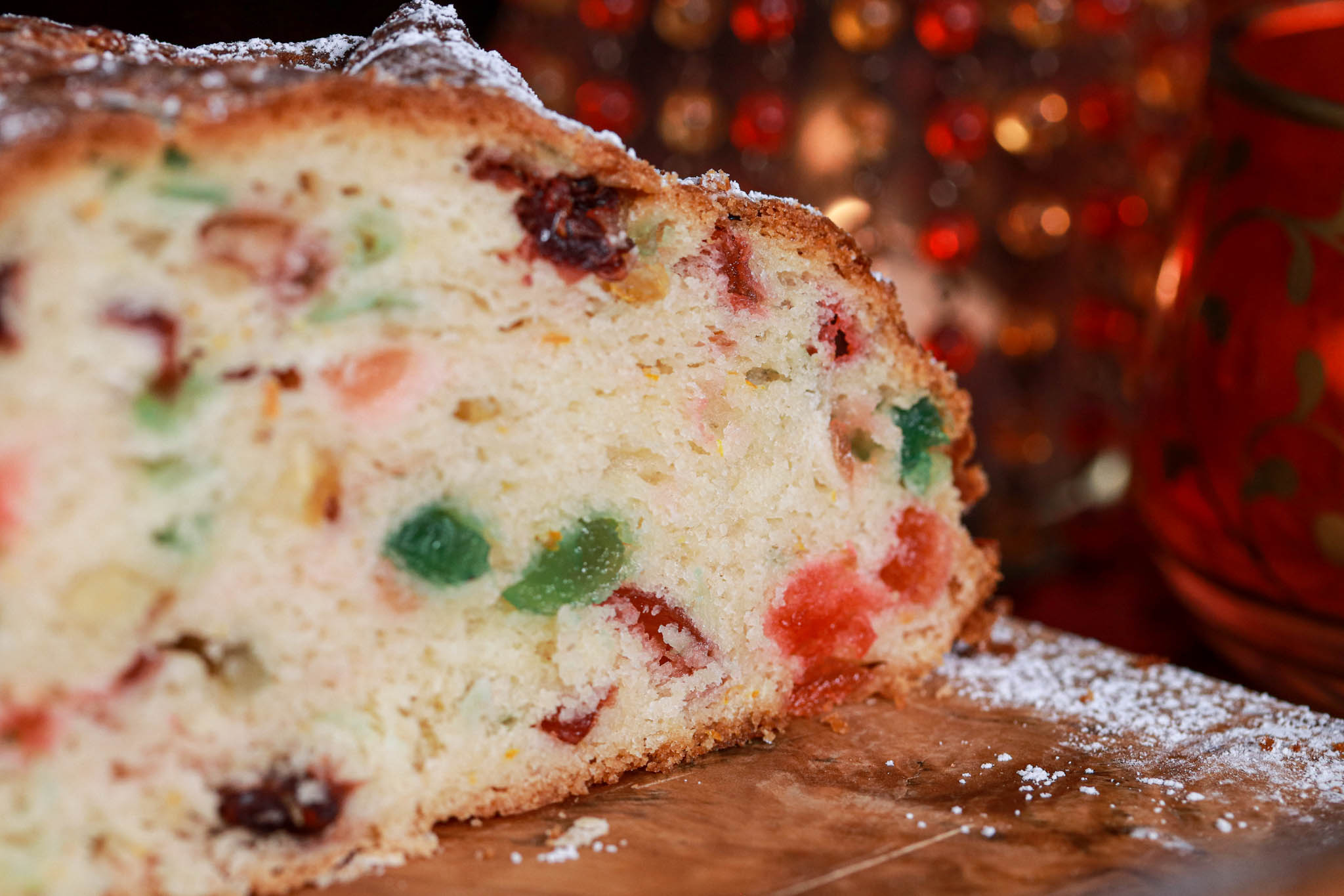 Gluten-free festive Fruit Bread slice on wooden board red velvet & decor