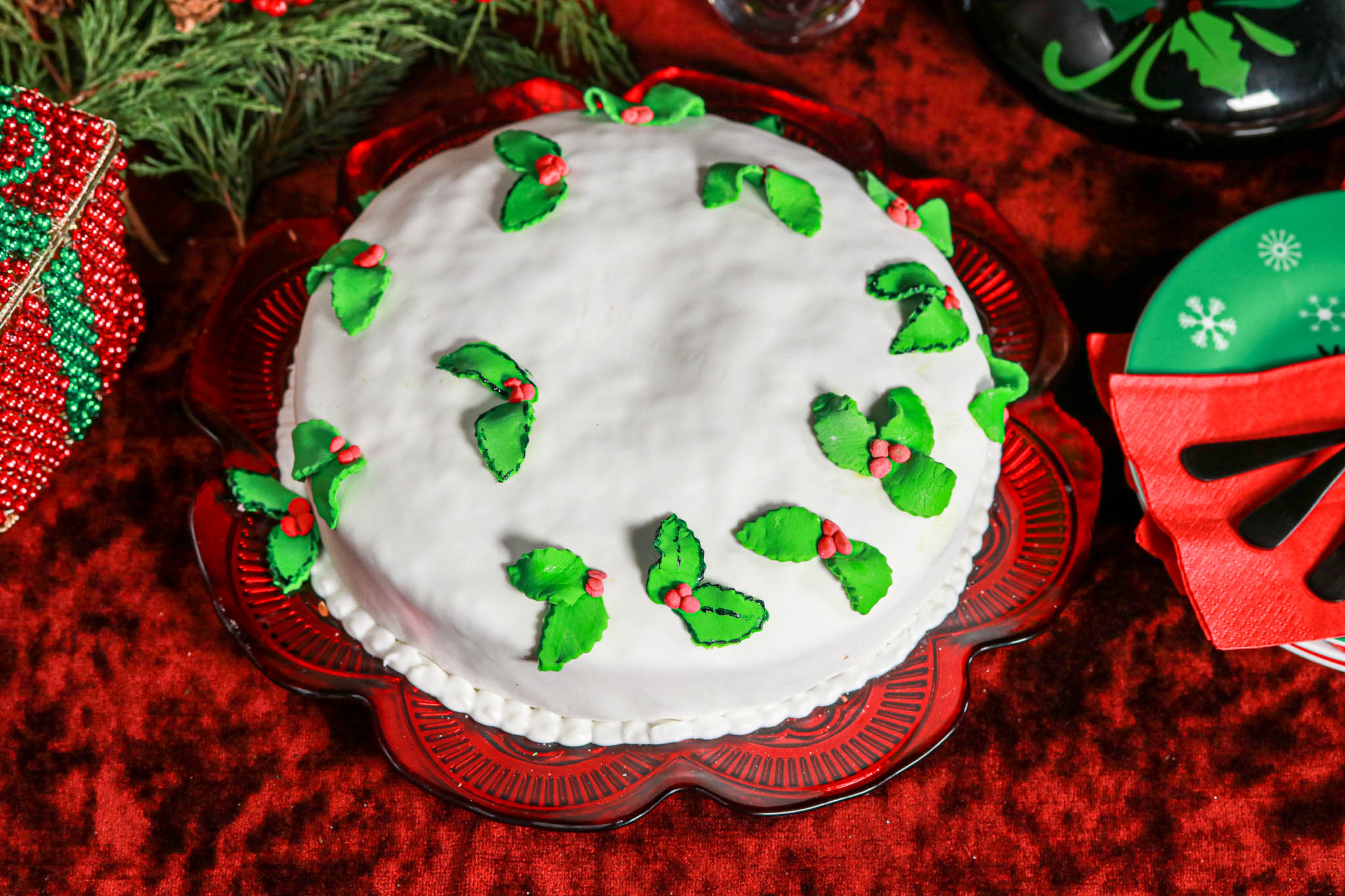 Festive Rum Cake gluten-free  on red velvet & decor