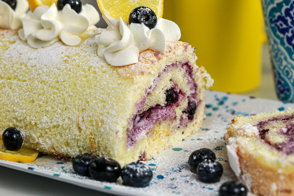 Gluten-free Lemon Blueberry Jelly Roll on a long blue white plate