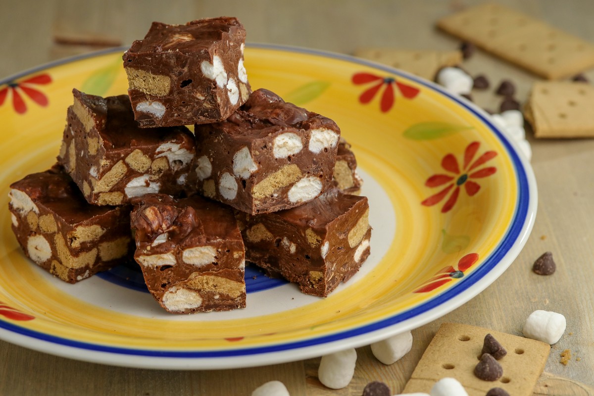 Gluten-free No Bake Smores in pyramid on yellow flower ethnic plate on wooden table top