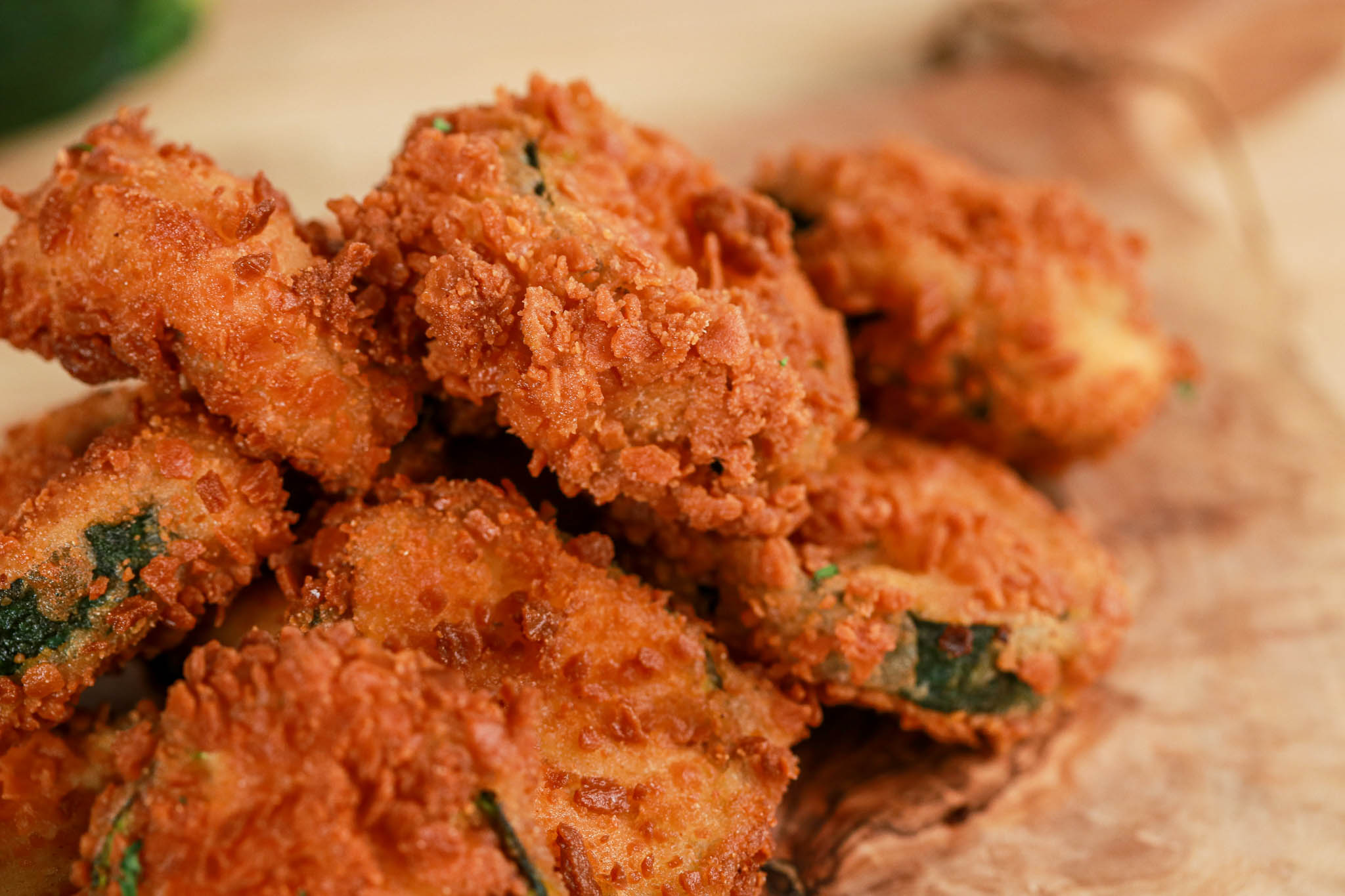 Gluten-free Panko Crusted Zucchini Chips CU on wooden board with lemon