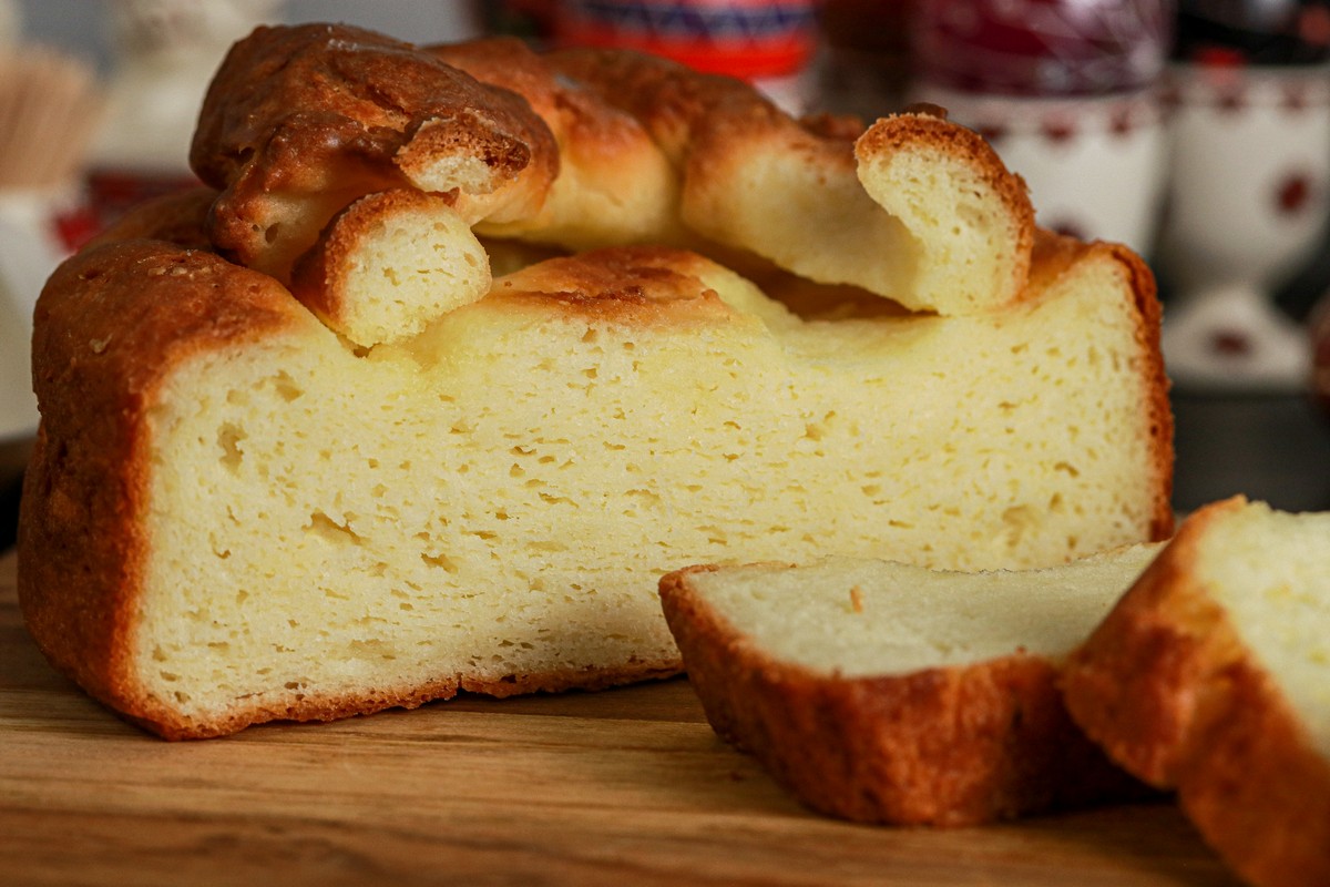 gluten-free Paska egg bread on Ukrainian dish with decorated Pysanka easter eggs in background