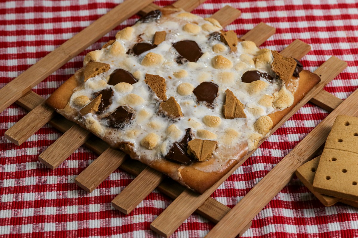 Smoreables Pizza on wooden cooling slat on red white chequered cloth